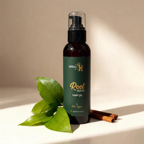 Root Reborn 300ml hair oil by Herbals by SH with fresh green leaves.